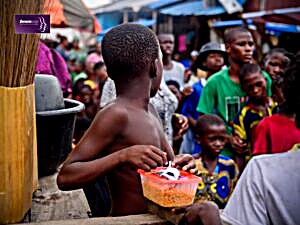 A boy holding a food pack at a DEVADI food security outreach