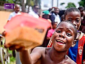 A DEVADI volunteer distributing supplies to a child